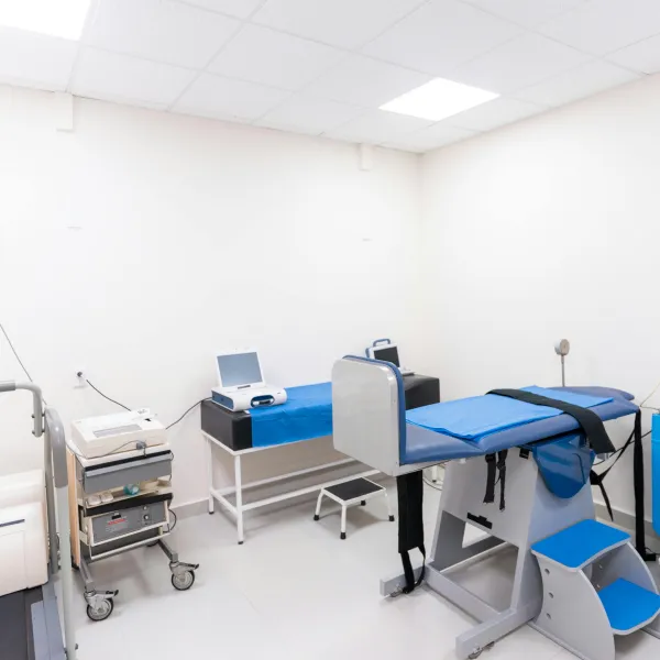 A clean and equipped medical examination room with diverse healthcare tools.